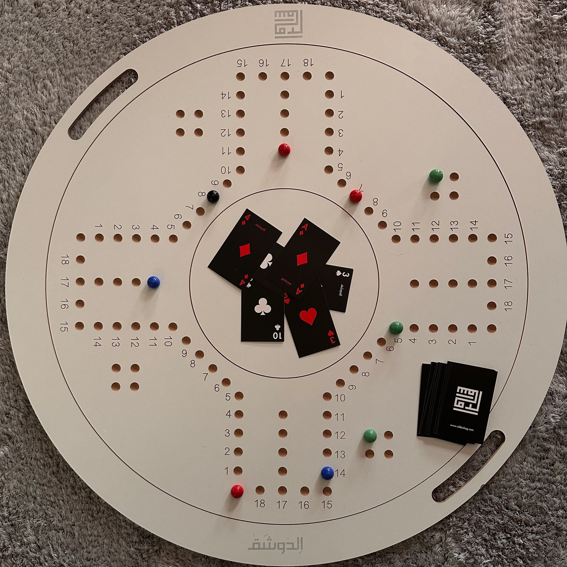 Circular board game with cards and markers on a textured surface